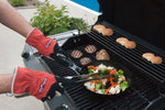 action shot of a grill cook using the gloves to cook, the bottle opener is out of the way, making the gloves easy to use